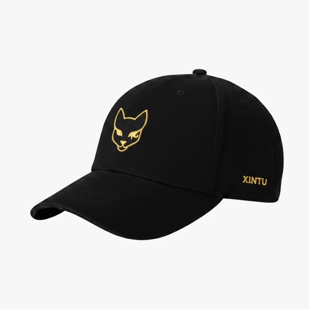 Angled view of the gold Xintu cap showing the curved brim